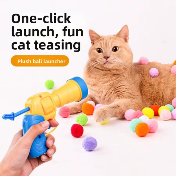 Juguete lanzador de bolas para gatos tipo pistola con pelotas de peluche de diferentes colores.
